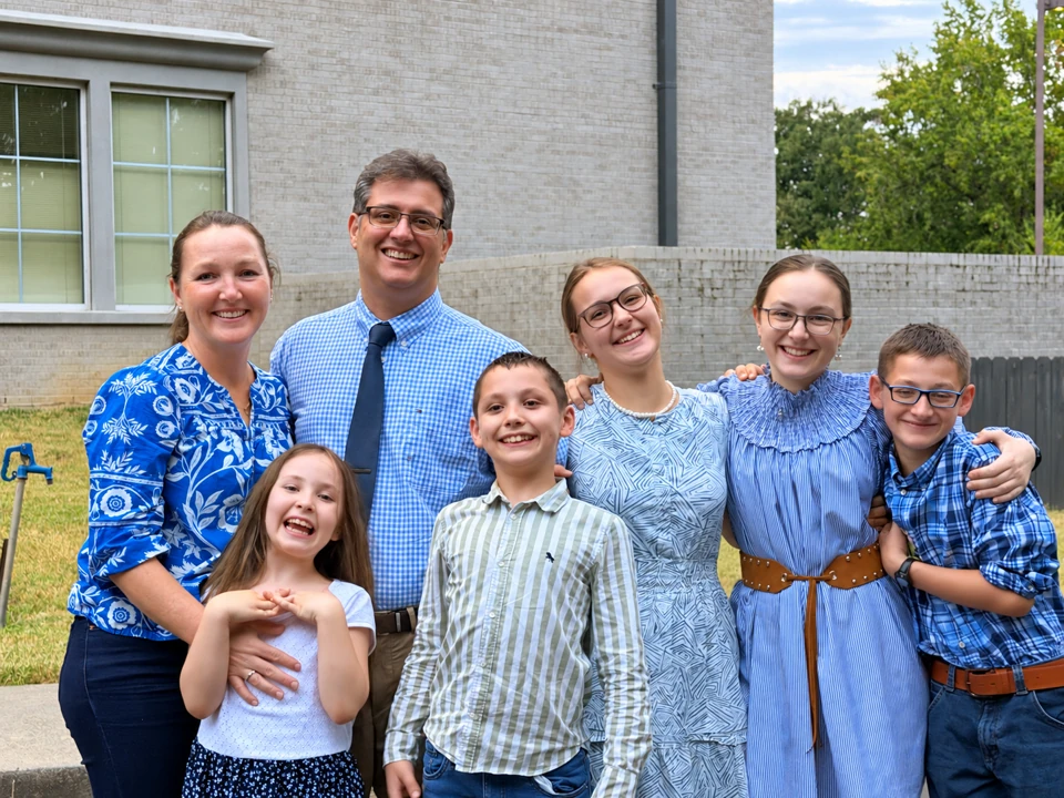The Knox Laser Creations family: parents and their five children standing together outdoors