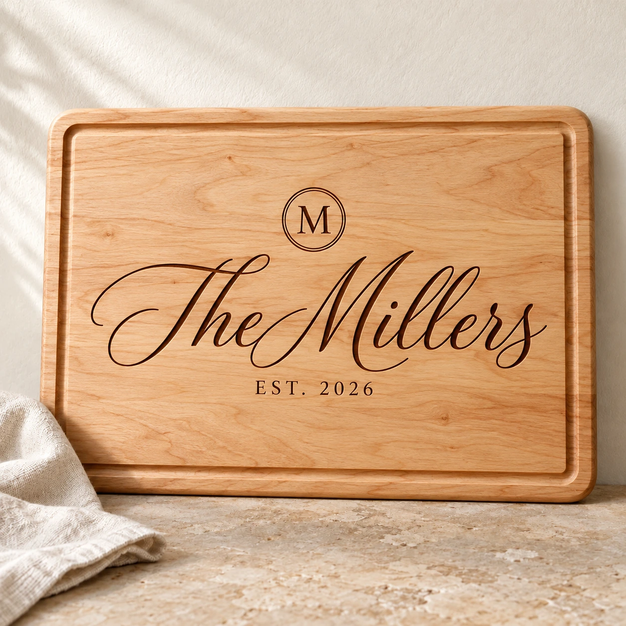 Large family-name engraving: Script · monogram on Maple.